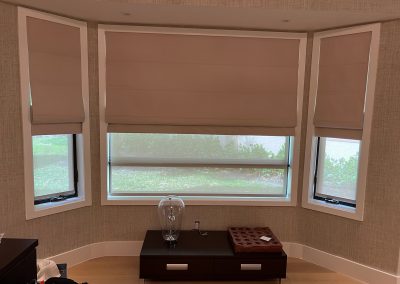 Roman shades in blackout and roller in screen